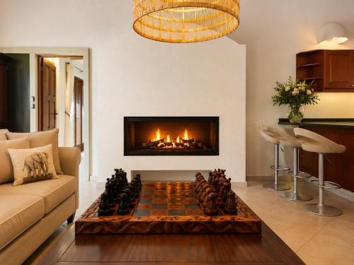 a living room with a chessboard in front of a fireplace at Amazing mountain views! Solar powered! in Hoedspruit