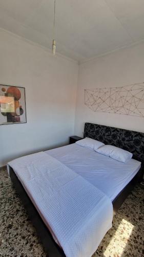 a bedroom with a large bed with a white comforter at Xilagani Central House in Xilaganí