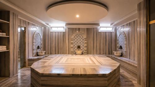 a large room with a large wooden table in the middle at Kleopatra Micador Otel in Alanya
