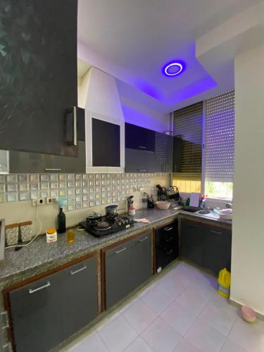 a kitchen with a purple light on the ceiling at Villa CULUPIA in Kelibia