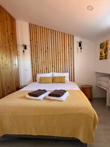 a bedroom with a bed with two towels on it at Ripado Loft in Ponta Delgada