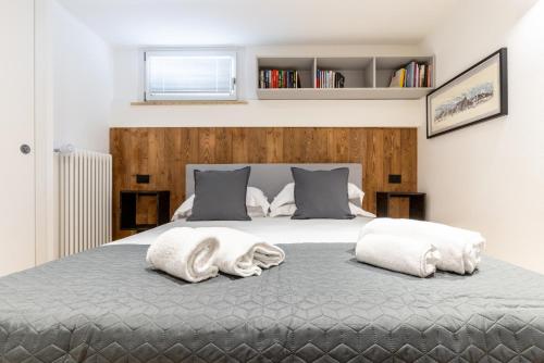 a bedroom with a bed with two towels on it at Aosta Centre Apartments - Santo Stefano in Aosta