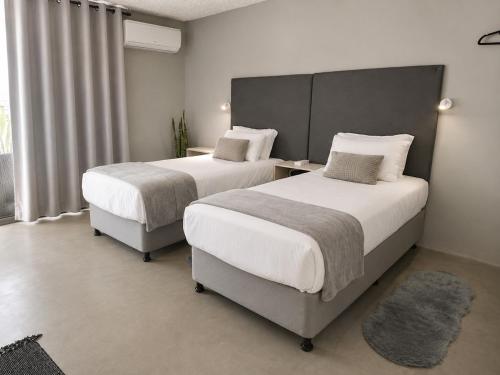a bedroom with two beds and a window at Camperdown Stay in Camperdown
