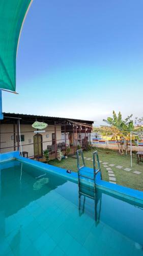 a blue chair sitting next to a swimming pool at Gravity Groups Core - La Maison Villa in Pondicherry