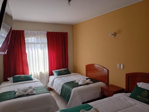 a hotel room with two beds and a window at Hotel Inka Luxe in Arequipa