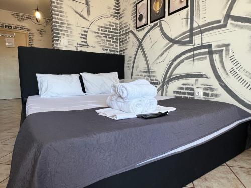 a bedroom with a bed with towels on it at Downtown Hub 1 in Alexandroupoli