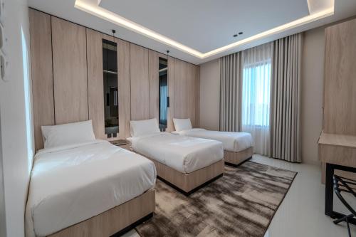 a hotel room with two beds and a piano at wend house in Jeddah
