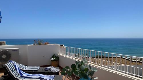 a balcony with a view of the ocean at BLUE OASIS Mojácar in Mojácar
