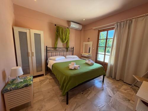 a bedroom with a bed with two stuffed animals on it at Condillia II in Spetses