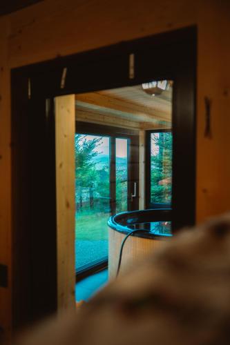 a room with a window with a view of a room at Mały Domek & Chatka Panorama in Lipowa