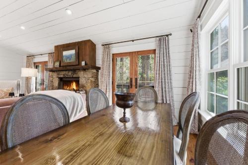 a dining room with a table and chairs and a fireplace at Sunset Nest in Highlands