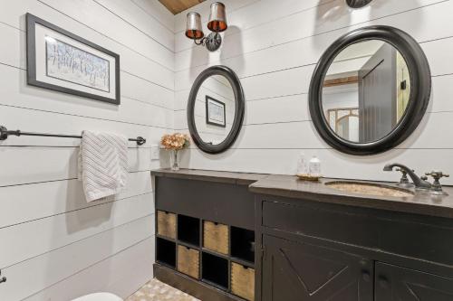 a bathroom with a sink and two mirrors at Sunset Nest in Highlands