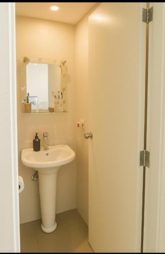 a white bathroom with a sink and a mirror at chalet in saint remon in Al ‘Ayn
