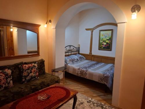 a living room with a bed and a couch at Atgiris in Palanga