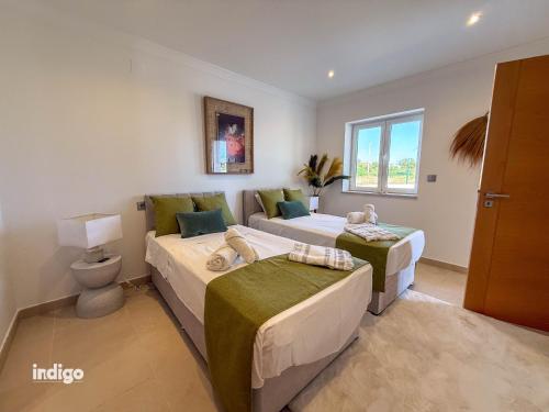 a bedroom with two beds and a couch at Villa Nichan - Private Pool - NIC01 in Ayamonte