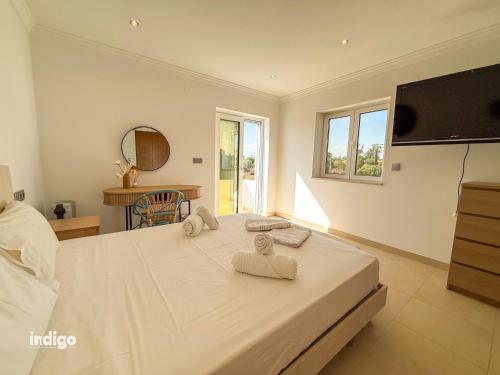 a bedroom with a bed with towels on it at Villa Nichan - Private Pool - NIC01 in Ayamonte