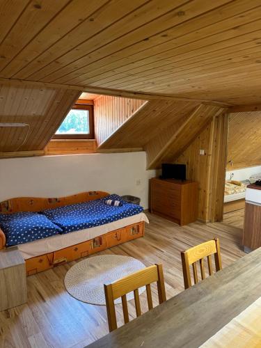 a bedroom with a bed and a table and chairs at Apartmán Gál 2 in Kvačany