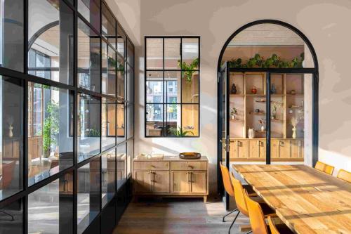 a dining room with a table and some windows at Beckett Locke in Dublin