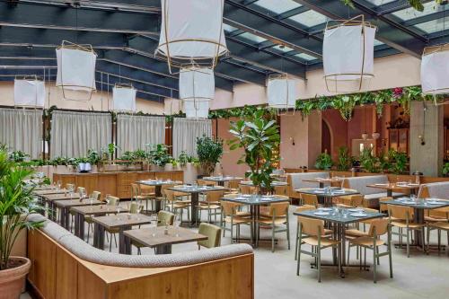 a restaurant with tables and chairs and plants at Beckett Locke in Dublin