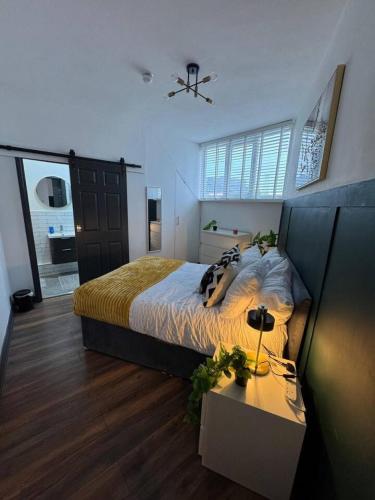a bedroom with a large bed and a table at The Recharge Loft in Durham