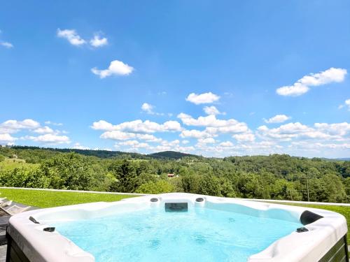 a hot tub with a view of the mountains at The East House ONE in Łapanów