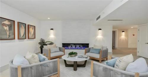 a living room with two couches and a table at Oceanview Serenity Escape in Naples