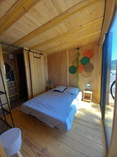 ein Schlafzimmer mit einem Bett in einem Holzzimmer in der Unterkunft la douceur du sud jardin terrasse in Clermont-lʼHérault