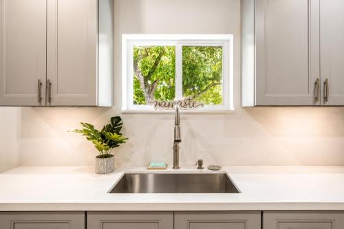 a white kitchen with a sink and a window at Cozy Private Triple Room in Design District Miami in Miami
