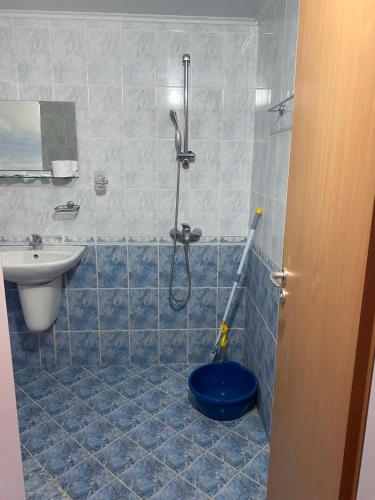 a bathroom with a shower and a toilet and a sink at Мирели in Ravda