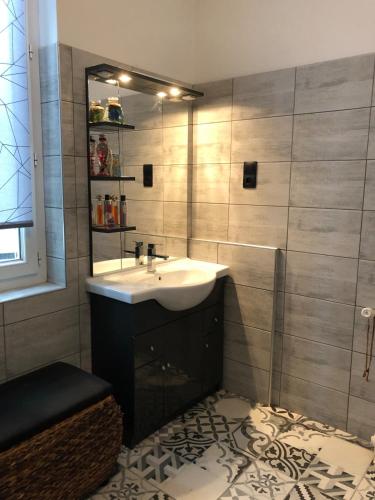 a bathroom with a sink and a mirror at Villa avec Piscine in Brive-la-Gaillarde