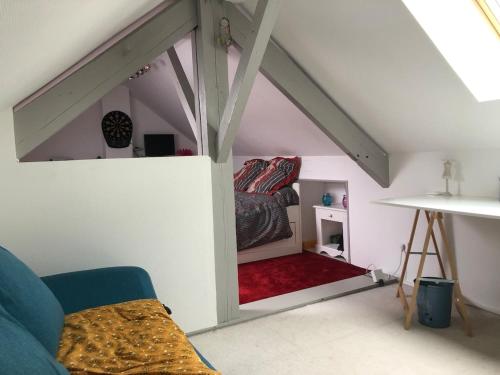a bedroom with a bed in a attic at Villa avec Piscine in Brive-la-Gaillarde