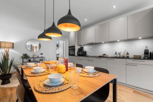 a kitchen with a wooden table with bowls of food on it at Chez Fridolin in Glarus