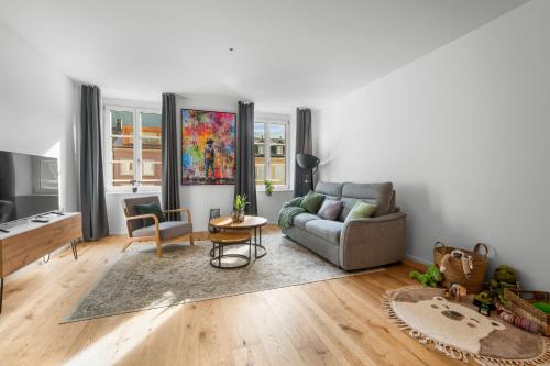 a living room with a couch and a table at Chez Fridolin in Glarus