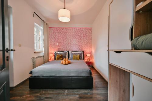 a bedroom with a bed with two pumpkins on it at Villa Bogijeva in Rabac