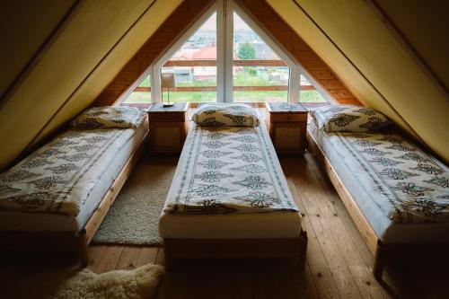 three beds in a room with a large window at Domek Panorama in Lipowa