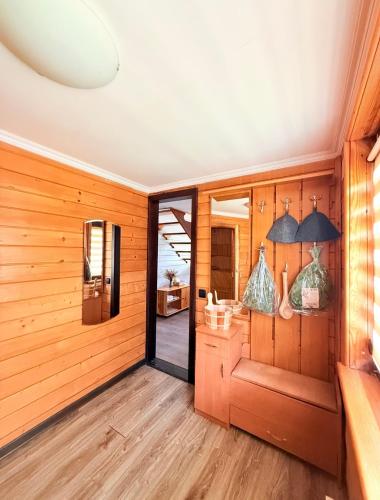 a room with wood paneling and a hallway with a door at Zoloche Chalet in Vishenki
