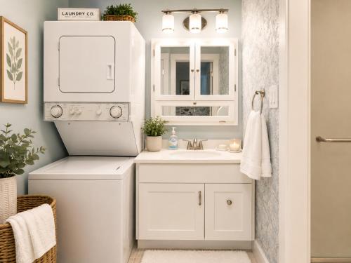 a white bathroom with a sink and a mirror at Private Beach, 2 Pools & Hot Tub in St. Petersburg