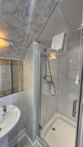 a bathroom with a shower and a sink at Corriemar House in Oban