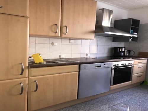 a kitchen with a sink and a stove top oven at White House Bochum II in Bochum