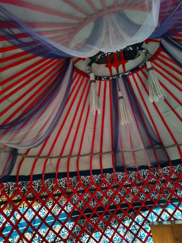 a red white and blue ceiling of a yurt at Дача in Bishkek