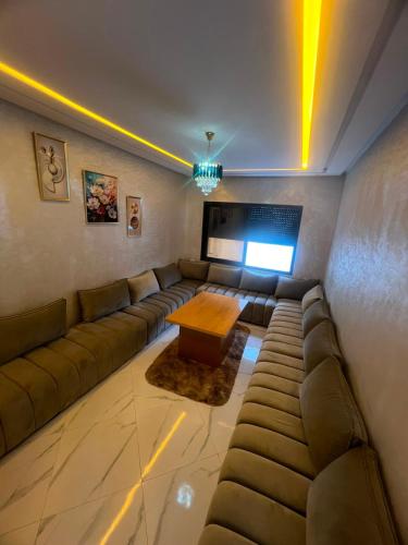 a living room with a couch and a table at relaxtime avec ascenceur in El Jadida