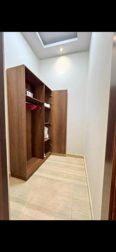 a room with a closet with wooden cabinets at Garden C Hotel Nile Plaza in Cairo