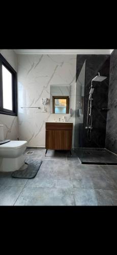 a bathroom with a tub and a sink and a toilet at Garden C Hotel Nile Plaza in Cairo