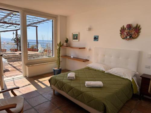 a bedroom with a bed and a large window at Il Nido del Gabbiano in Vietri sul Mare