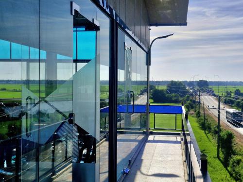 a glass building with a view of a highway at Town Tulip in Karativu