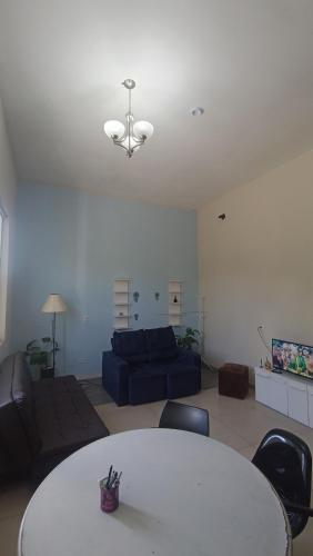 a living room with a table and a couch at Studio Home 4 in Jacareí