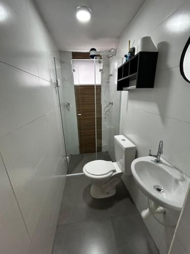 a bathroom with a toilet and a shower and a sink at Studio Home 4 in Jacareí