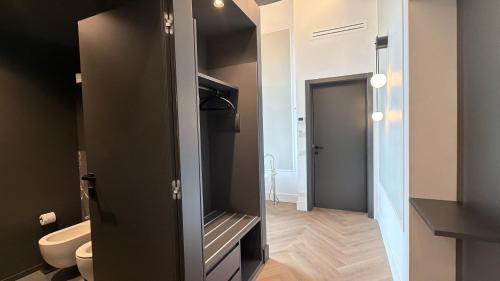 a bathroom with a toilet and a mirror in it at Palazzo Montella in Naples