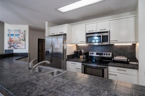 a kitchen with stainless steel appliances and white cabinets at 3017 Ocean Winds in Seabrook Island