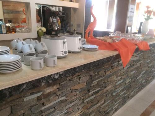 a counter with plates and crockpots on it at La Frida Hotel - ADULTS ONLY in Nono